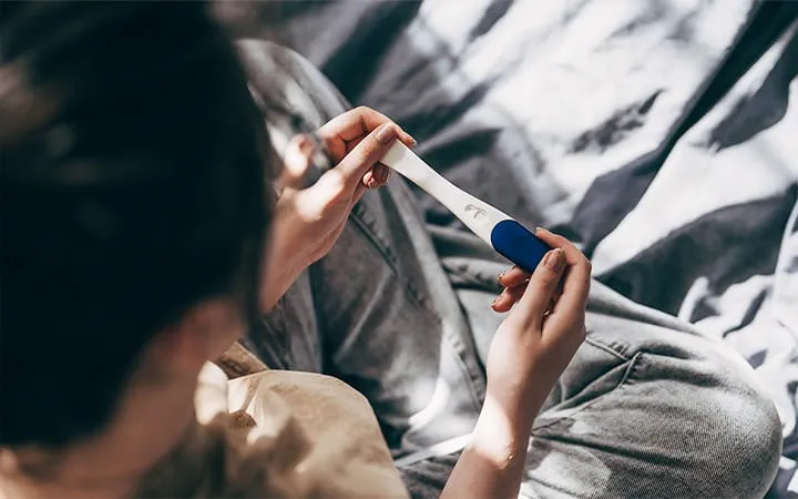 A woman viewing the results of a pregnancy test